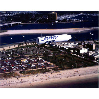 Sheik Banner being towed by airplane over beach area